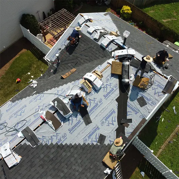 Team of roofers installing new roofing materials